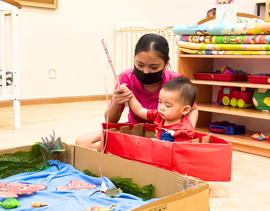 one of PTCC Teacher playing with kids | Pink Tower Childcare Center